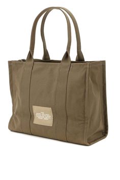 The Large Tote is a carryall that’s ready for an overnight, a plane ride or a day at the office. Crafted from textural cotton canvas, this silhouette is intended to fade and relax over time for an authentically broken-in look that Marc himself loves to wear. This spacious tote features a chunky top-sip closure, namesake branding, multiple inside pockets, sturdy top handles and room for anything you might need. Carry yours by the top handles or wear over your shoulder. Marc Jacobs Tote, Boutique Online, Large Tote Bag, Roberto Cavalli, Green Cotton, Green Bag, Womens Tote, Luxury Retail, Large Tote