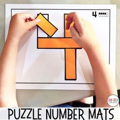 a person is making a puzzle number mats