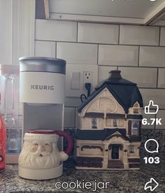 there is a coffee maker next to a cookie jar on the kitchen counter with santa's face