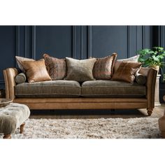 a living room with a couch, chair and ottoman in brown leather upholster