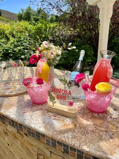 a table topped with pink vases filled with flowers