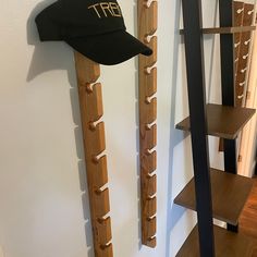 there is a hat hanging on the wall next to some wooden ladders and shelves