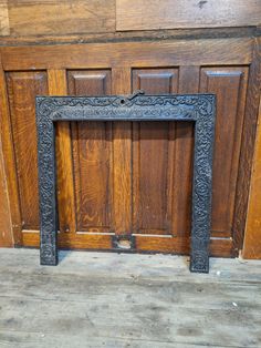 an ornate fireplace surround in front of a wooden door