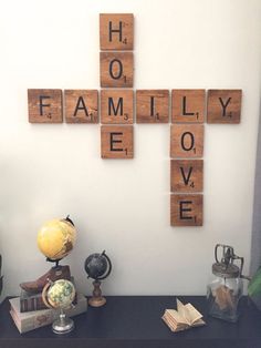 a cross made out of scrabble tiles sitting on top of a desk