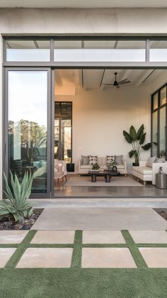 an open living room and patio area with green grass