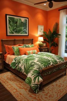 a bedroom with an orange wall and palm leaves on the bedding, along with a ceiling fan