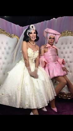 two women dressed in pink and white sitting next to each other