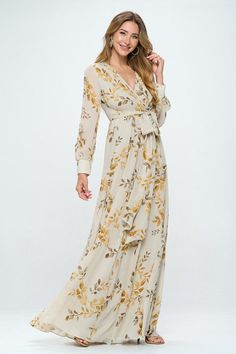 Introducing our stunning floral maxi dress. This dress features beautiful bubble sleeves and a flattering v-neckline, as well as a wrapped waist tie detail that helps create a stunning silhouette. The metallic threads and gold button details add an extra touch of glamour to this already stunning dress. The body of the dress is fully lined, ensuring both comfort and modesty, while the see-through sleeves add an elegant touch. The elastic waistband makes this dress perfect for expectant mothers, a White Floral Print Maternity Maxi Dress, Feminine Floral Print Maternity Maxi Dress, Bohemian Floral Print Maternity Maxi Dress, Fitted Maternity Dress With Floral Print And V-neck, Maternity V-neck Maxi Dress With Floral Print, Modest Tops, Gold Buttons, Floral Maxi, Metallic Thread