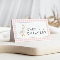 a place card sitting on top of a cutting board with deer antlers in the background