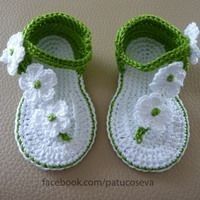 crocheted baby shoes with flowers on them