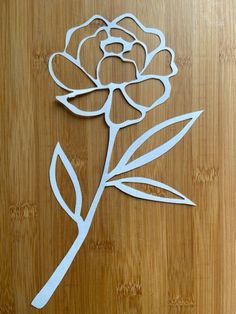 a cut out flower sitting on top of a wooden table