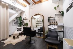 a salon with black chairs and white walls