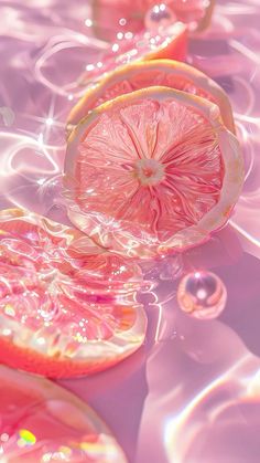 a grapefruit cut in half sitting on top of water with bubbles around it