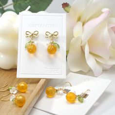 Embrace the radiance of this golden shiny orange fruit earrings and let it be the finishing touch that elevates your confidence and charm. 🍊Premium Material: handmade high quality with Czech glass oranges, acrylic flowers, acrylic leaves, and 14K gold plated/925 sterling silver-plated ear hooks (hypoallergenic).  🌺Size: the hook style is about 0.6" wide and 1.35" long | the stud style is about 0.6" wide and 1" long 💌Handmade: Each item is made to order, which gives our pieces a unique meaning Orange Jewelry With Fruit Design For Gifts, Orange Fruit Design Jewelry For Gift, Orange Fruit Design Jewelry Gift, Orange Drop Earrings For Anniversary, Fruit Design Drop Earrings As Gift, Fruit Design Drop Earrings For Gift, Gold Earrings With Fruit Design For Gift, Elegant Apricot Earrings For Gift, Yellow Fruit Design Earrings For Gift