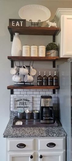 a kitchen with white cabinets and open shelves