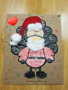 a paper bag with a drawing of santa claus on it and a red heart in the background