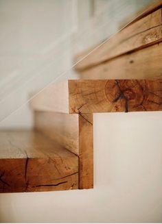 closeup of wooden stairs with white walls