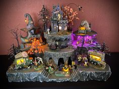 an elaborate halloween display with lights and figurines