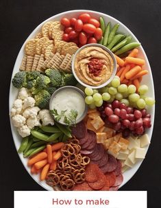 a white plate topped with lots of different types of vegetables and crackers on top of it