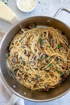 pasta with mushrooms and parmesan cheese in a pan