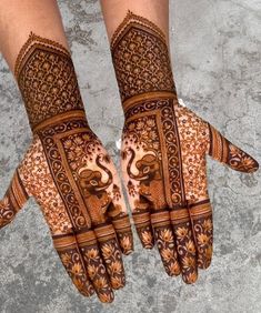 two hands with henna designs on them