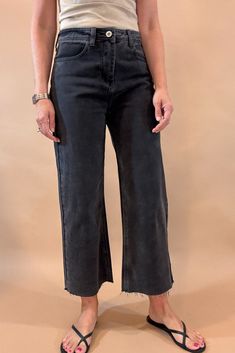 Get ready to rock the edgy chic look with these Black Crop Wide Leg Jeans. With a 23 1/2 inch seam, raw hem, slight (very slight) stretch, and distressed details, they exude effortless coolness. The lightweight denim is tapered in the back for the perfect fit, while maintaining the relaxed wide leg style. Dare to be different! Fit is true to size, Amber is modeling size small. She is 5’6”. Imported Cotton blend. Mid-rise Black Pants With Frayed Hem, Edgy Frayed Hem Jeans For Fall, Trendy Black Cropped Jeans With Frayed Hem, Black High-rise Cropped Jeans With Frayed Hem, Black High Rise Cropped Jeans With Frayed Hem, Black Cropped Jeans With Frayed Hem For Fall, High Rise Black Cropped Jeans With Frayed Hem, Spring Mid-rise Black Cropped Jeans, Straight Leg Pants With Frayed Hem For Fall