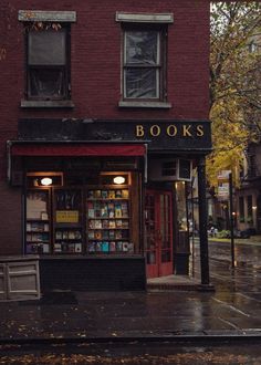 a book store sitting on the side of a street next to a red brick building