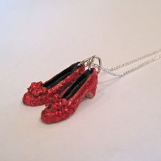 "This Wizard of Oz Necklace that features Dorothy's shimmering Ruby Red Slippers are handmade!  Dorothy's Ruby Red slippers are 3D and highly detailed with the perfect little heels and bows! The shimmering glitter used on the slippers make them glittery/metallic red like the actual shoes from the film! A perfect leaving home gift, Wicked lover or for the shoe lover in your life!  Follow the yellow brick road! These Ruby Red Slippers are handmade of polymer clay.  They measure 13/16\" long. The c Red Slippers Wizard Of Oz, Disney Couture Jewelry, Dorothy Costume, Miniature Shoes, Silver Slippers, Ruby Red Slippers, Steam Girl, Red Slippers, Ruby Slippers