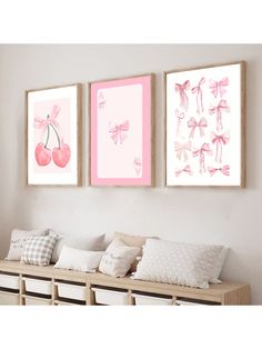 two pink paintings hanging on the wall above a bench with pillows and pillow cases in front of them