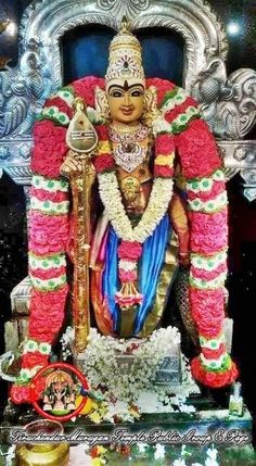 the statue is decorated with flowers and decorations