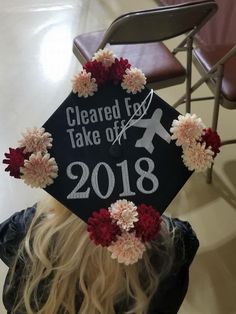 a black graduation cap with flowers on it