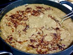 a pan filled with food sitting on top of a stove