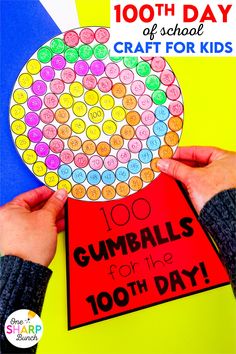 a hand holding up a gumballs for the 100th day of school