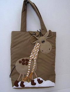 a brown bag with a giraffe design on the front and side, hanging from a wall