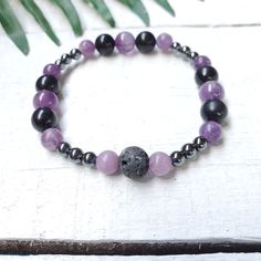 Amethyst, Lepidolite, Shungite and Hematite Bracelet.  I made this bracelet with the intention to help open you up to higher realms, intuition and dream recall while also being grounded and  protected.  Amethyst enhances your intuition and helps you to trust yourself.  Lepidolite helps you to be open to understanding your dreams. Helps you to be able to calm down and be open. Shungite helps us to detox our life and know what is most important in our lives at the moment and what knowledge is comi Healing Hematite Bracelets With Natural Stones, Spiritual Hematite Bracelets For Healing, Healing Hematite Bracelet With Natural Stones, Black Amethyst 8mm Bead Bracelets, Black Amethyst Bracelet With 8mm Beads, Black Amethyst Bracelets With 8mm Beads, Black Amethyst Crystal Bracelet In Spiritual Style, Spiritual Hematite Bracelet With Natural Stones, Black Amethyst Beaded Bracelets Spiritual