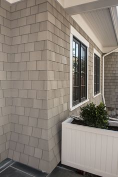 there is a planter in front of the window on the side of the house