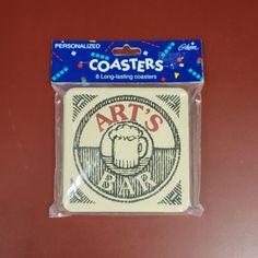 a package of coasters with an art's bar logo