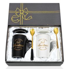 two coffee mugs in a gift box with gold spoons and a black handle