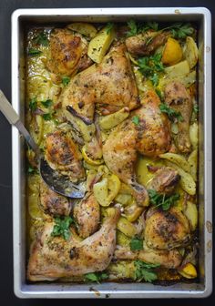 chicken and potatoes in a casserole dish with a spoon