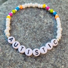 Colourful Rainbow Autistic Bracelet. Stretch Bracelet.  Made with seed, silver plated and letter beads. Pride Beads Bracelet, Bracelet Ideas Letters, Bracelet Letter Ideas, Bracelet With Letters, Letter Bracelet Beads, Letter Bracelet, Kandi Bracelets, Rainbow Bracelet