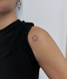 a woman with a small star tattoo on her arm