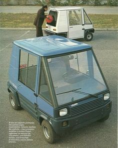 an advertisement for a small car in the middle of a parking lot with a man standing next to it