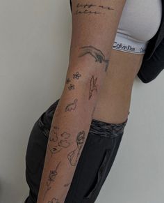 a woman's arm with tattoos on it