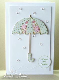 a card with an umbrella and polka dots