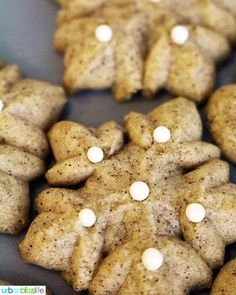 some cookies with white frosting on them are arranged in the shape of snowflakes