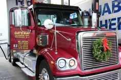 a red semi truck with a wreath on the front