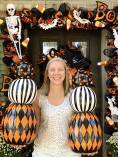 a woman standing in front of a door decorated with halloween decorations