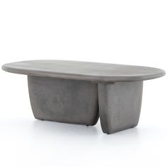 an oval concrete table with two legs