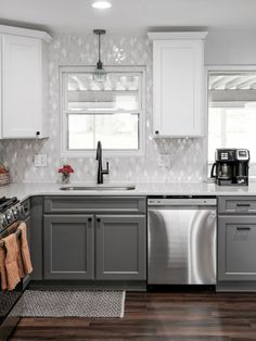 a kitchen with white cabinets and stainless steel dishwasher in the center, along with wood flooring