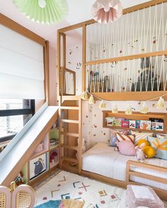 a child's bedroom with bunk beds, stairs and rugs on the floor